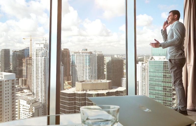 Businessman on the phone standing by the window
