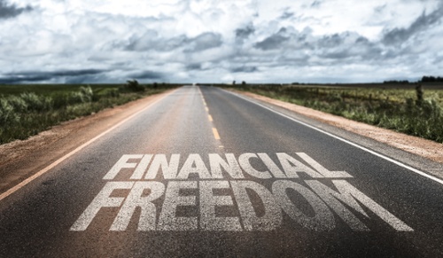 Financial Freedom written on rural road-1-1