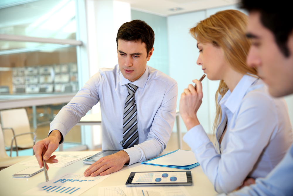 Manager presenting budget to marketing people-1